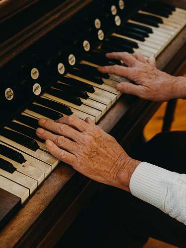musical instrument person playing piano during daytime piano